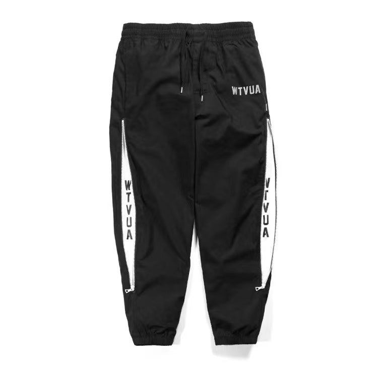 WTAPS pantalon en nylon de style décontracté décoré à fermeture à glissière latérale