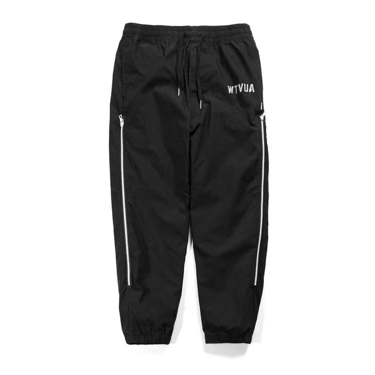 WTAPS pantalon en nylon de style décontracté décoré à fermeture à glissière latérale