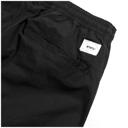 WTAPS pantalon en nylon de style décontracté décoré à fermeture à glissière latérale