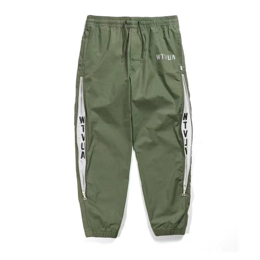 WTAPS pantalon en nylon de style décontracté décoré à fermeture à glissière latérale