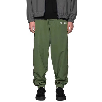 WTAPS pantalon en nylon de style décontracté décoré à fermeture à glissière latérale